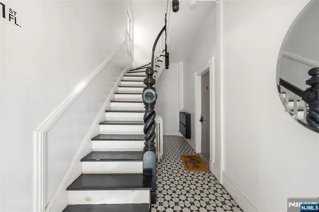 a view of entryway with stairs and wooden floor