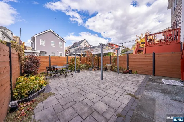 a view of a house with wooden fence