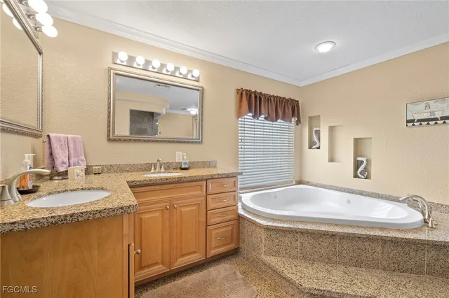 a bathroom with a granite countertop sink mirror and bathtub
