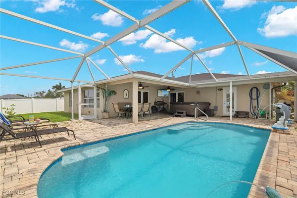 a view of a house with swimming pool and sitting area
