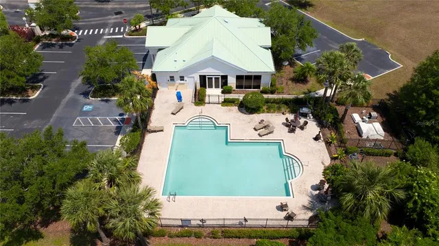 an aerial view of a house with yard swimming pool and outdoor seating