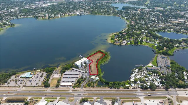 an aerial view of a house with a yard and lake view