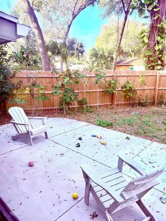 a view of a yard with large trees