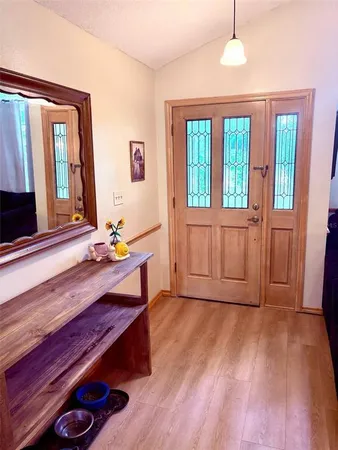 a view of a room with wooden floor and fan