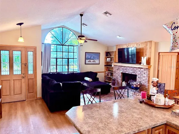 a living room with furniture fireplace and window
