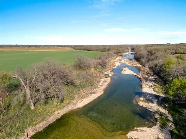 a view of a lake with a yard