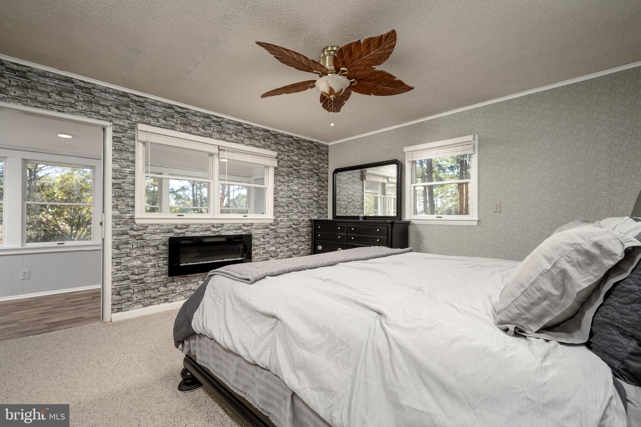 5053 Manokin Road Crisfield, MD 21817 - Photo 19 of 44 Master bedroom with electric fireplace