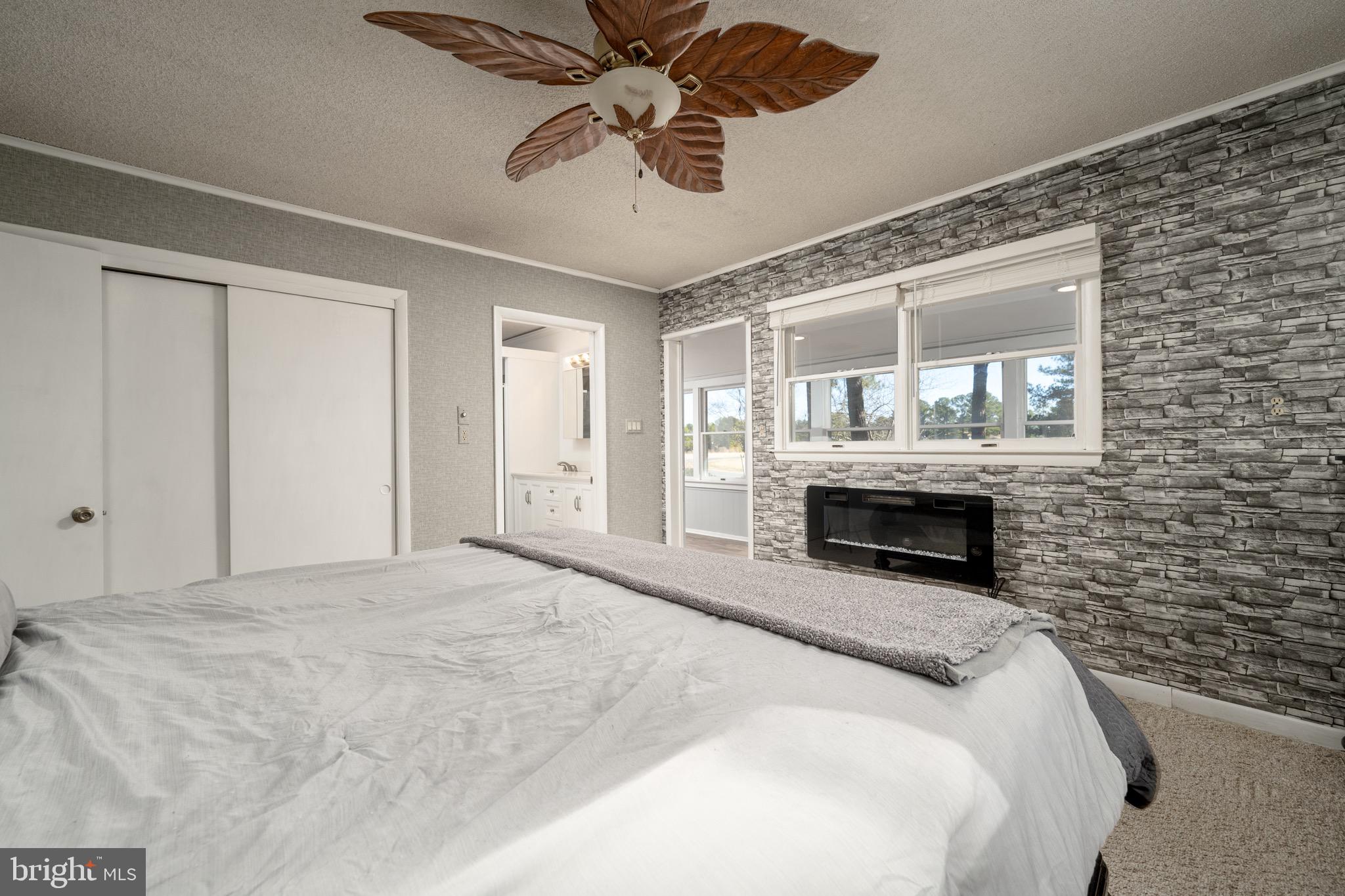5053 Manokin Road Crisfield, MD 21817 - Photo 20 of 44 Master bedroom with electric fireplace