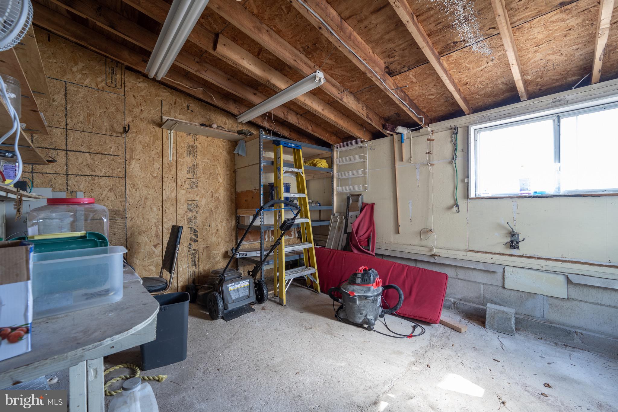 5053 Manokin Road Crisfield, MD 21817 - Photo 33 of 44 storage off garage w/ door access to backyard