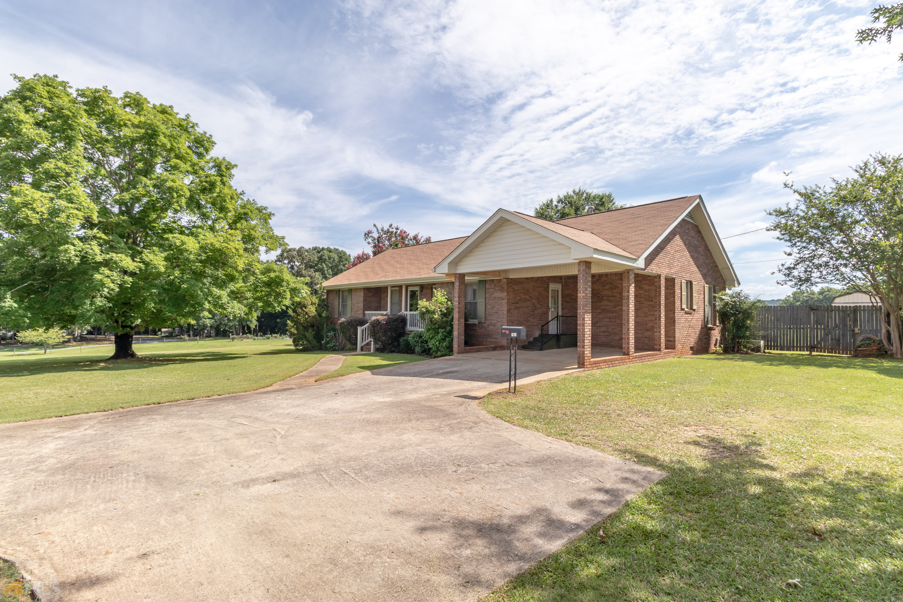 164 Jones Road Molena, GA 30258 - Photo 4 of 25 a front view of a house with a garden and trees