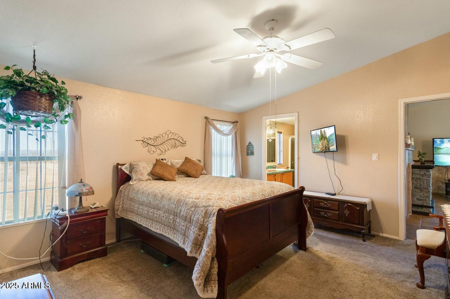 5780 South Mescalero Road Hereford, AZ 85615 - Photo 12 of 45 a bedroom with a bed furniture and a chandelier