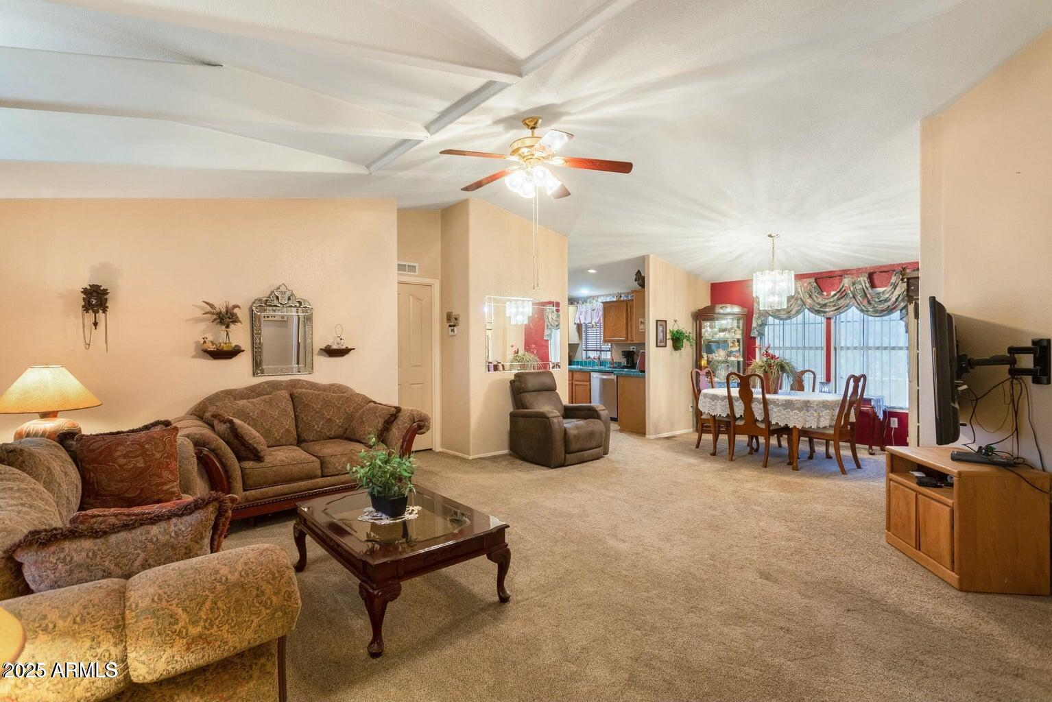 5780 South Mescalero Road Hereford, AZ 85615 - Photo 17 of 45 a living room with furniture and a chandelier