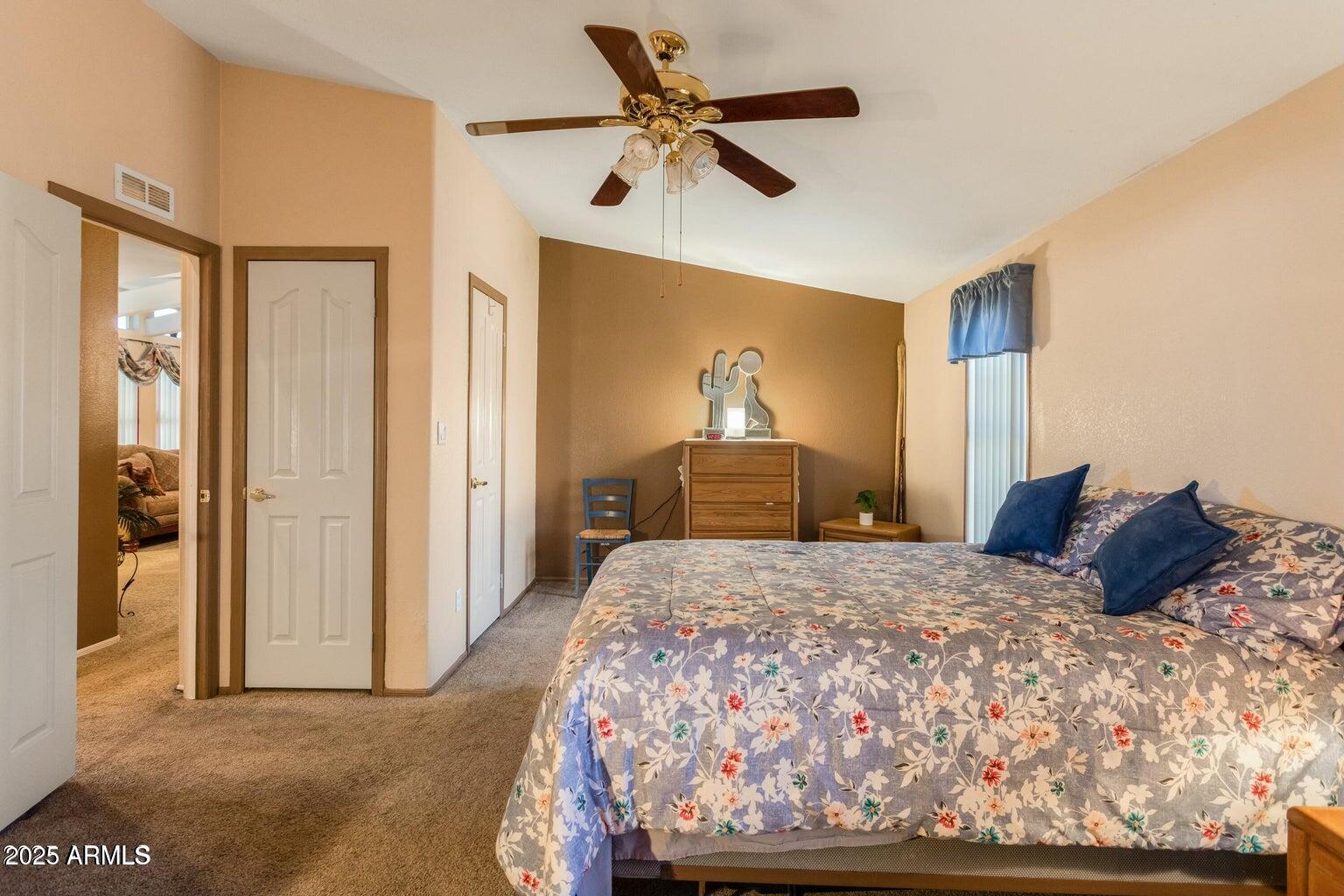 5780 South Mescalero Road Hereford, AZ 85615 - Photo 20 of 45 a bedroom with a bed and a chandelier