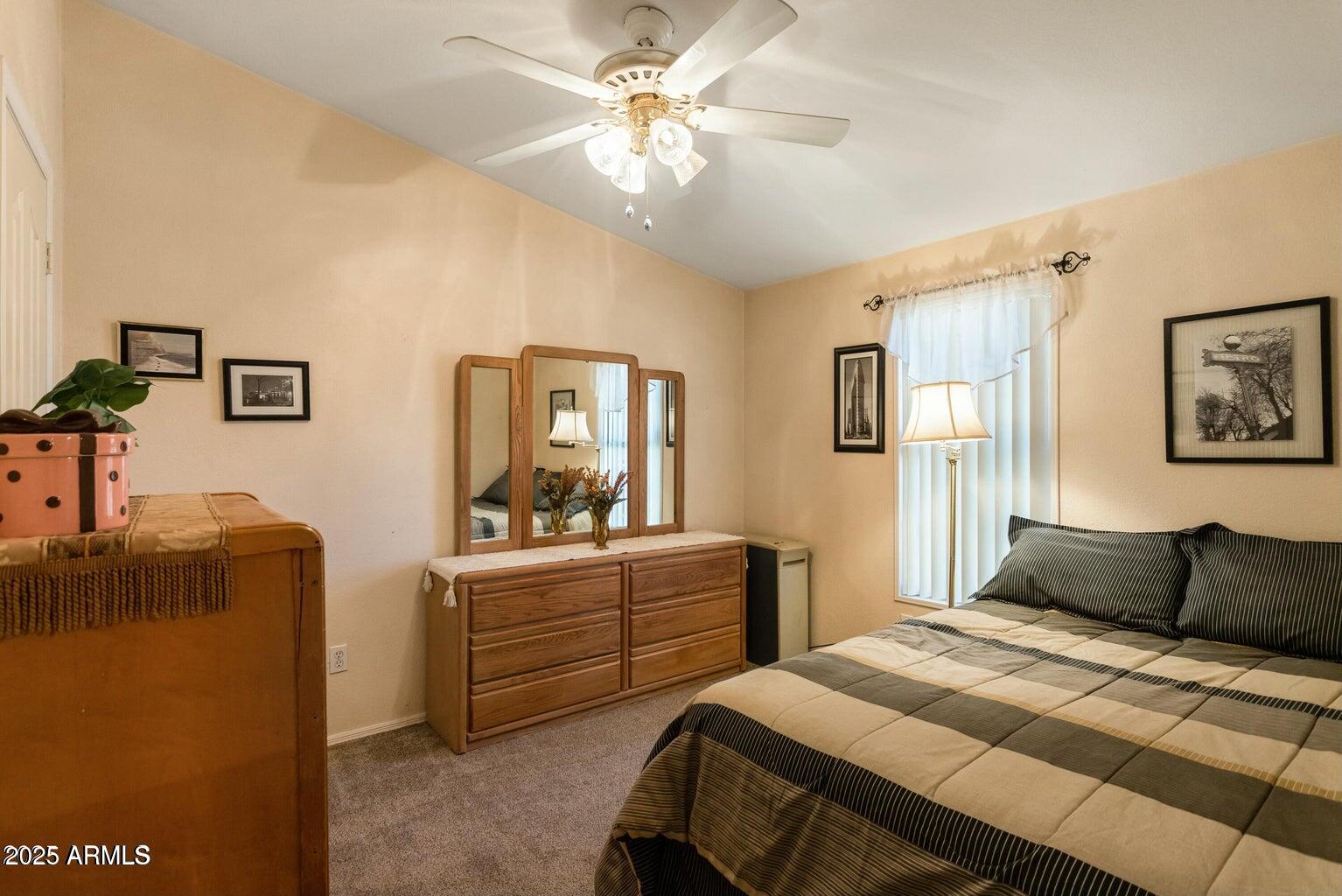 5780 South Mescalero Road Hereford, AZ 85615 - Photo 21 of 45 a bedroom with a bed and a chandelier