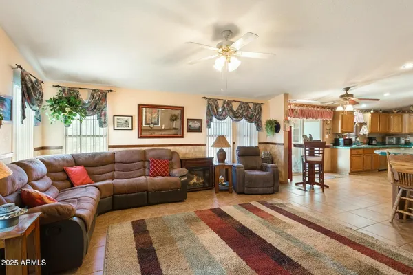 a living room with furniture and a view of kitchen