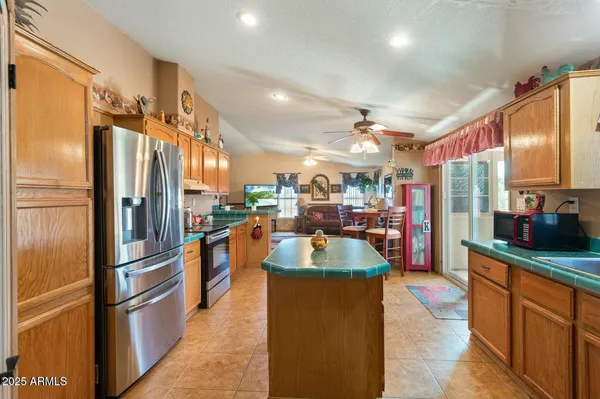 a kitchen with stainless steel appliances granite countertop sink refrigerator and microwave