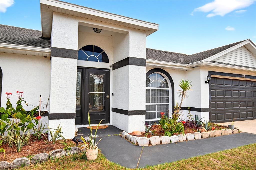 7839 Southwest 63rd Ave Road Ocala, FL 34476 - Photo 2 of 41 a front view of a house with a yard