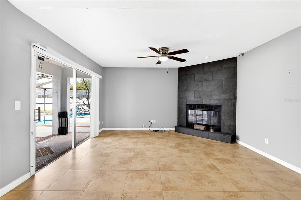 7839 Southwest 63rd Ave Road Ocala, FL 34476 - Photo 24 of 41 a living room with furniture and a fireplace