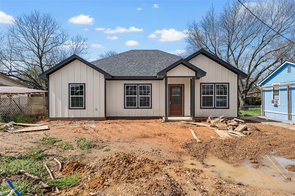 211 Lopez Street Bellmead, TX 76705 - Photo 2 of 15 a front view of a house with a dirt yard and a large tree