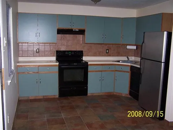 a kitchen with a sink and a refrigerator
