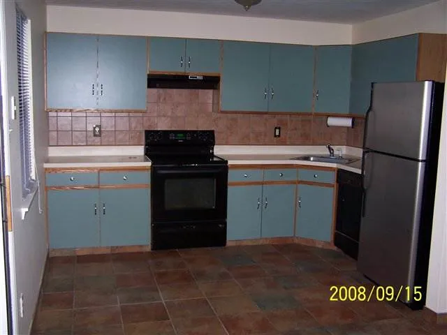 a kitchen with a sink and a refrigerator