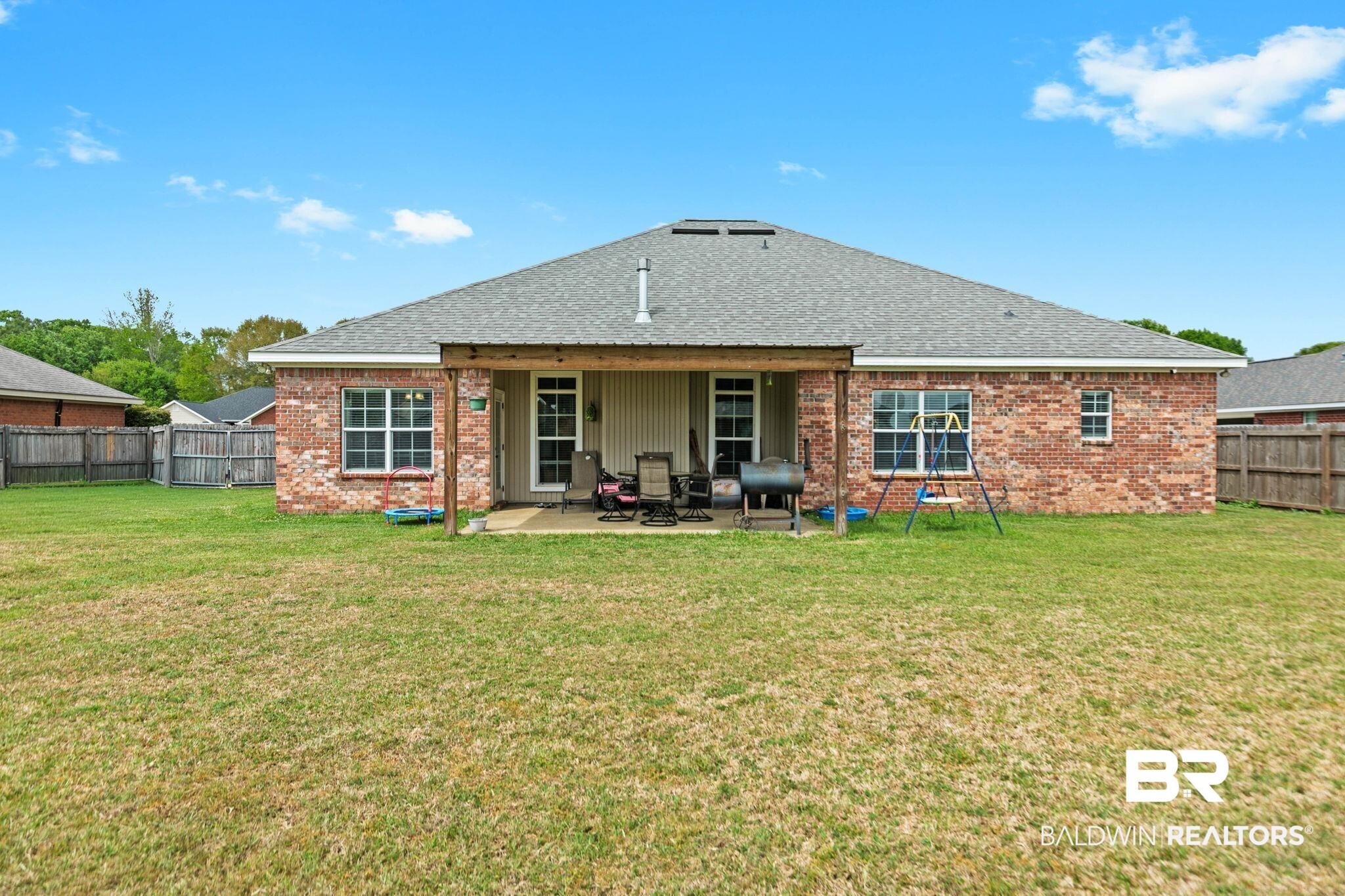 9177 Labrador Trail Theodore, AL 36582 - Photo 21 of 24 Rear view of property with brick siding, a fenced backyard, a patio, and roof with shingles