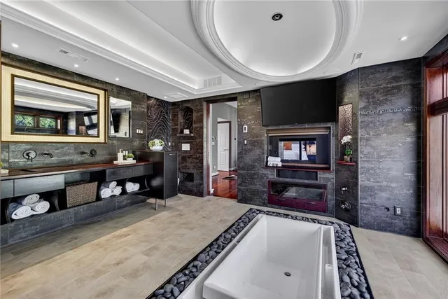 a view of a hallway with wooden floor and windows