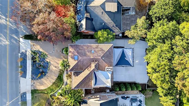 a front view of a house with a tree