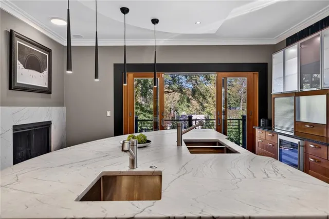 a kitchen with stainless steel appliances granite countertop a sink a stove and a refrigerator