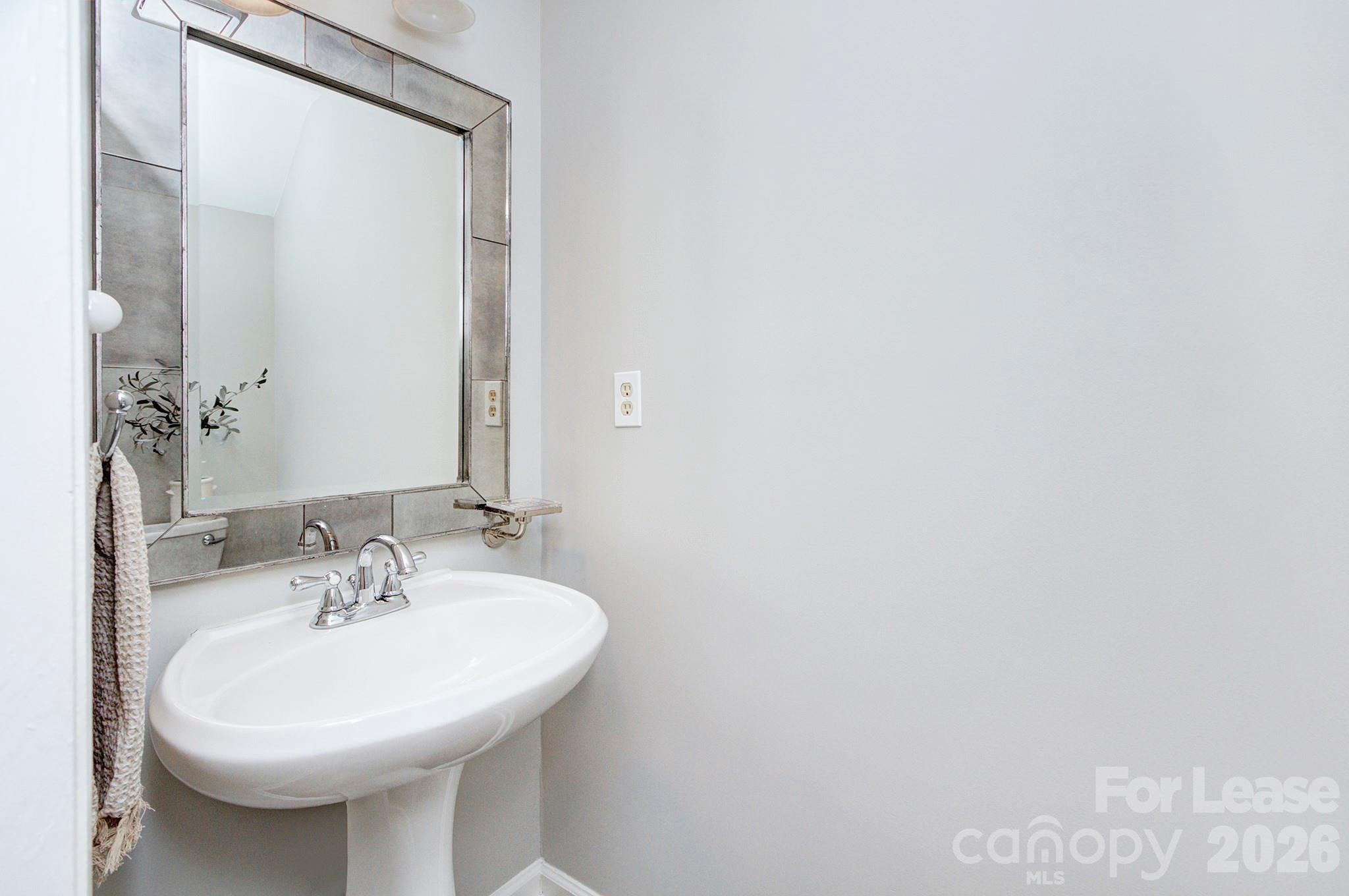 8268 Golf Ridge Drive Charlotte, NC 28277 - Photo 14 of 24 a bathroom with a sink and a mirror