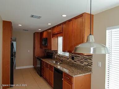 768 White Pine Avenue Rockledge, FL 32955 - Photo 3 of 9 a kitchen with stainless steel appliances granite countertop a sink and a stove