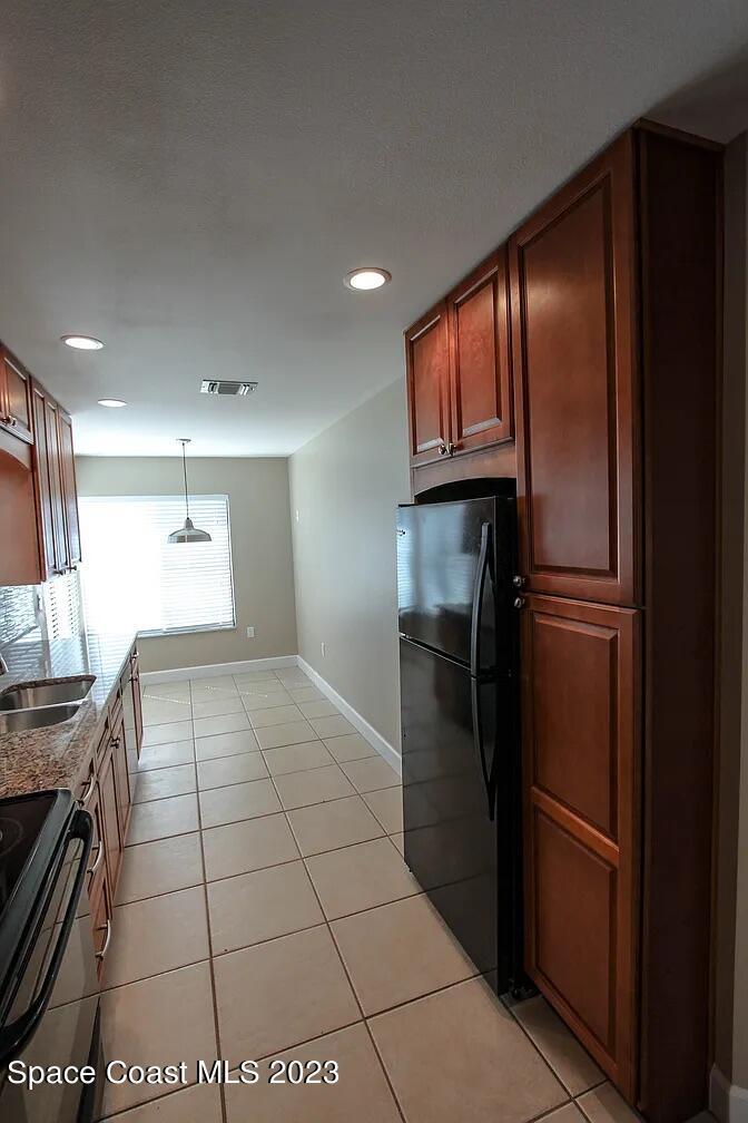 768 White Pine Avenue Rockledge, FL 32955 - Photo 5 of 9 a kitchen with stainless steel appliances granite countertop a refrigerator and a sink
