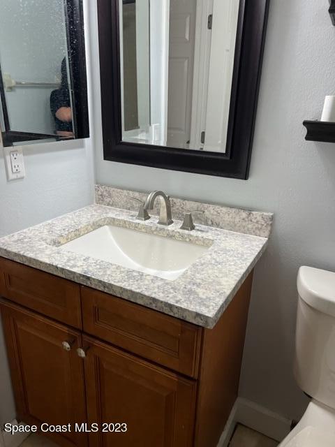 768 White Pine Avenue Rockledge, FL 32955 - Photo 9 of 9 a bathroom with a granite countertop sink and a toilet