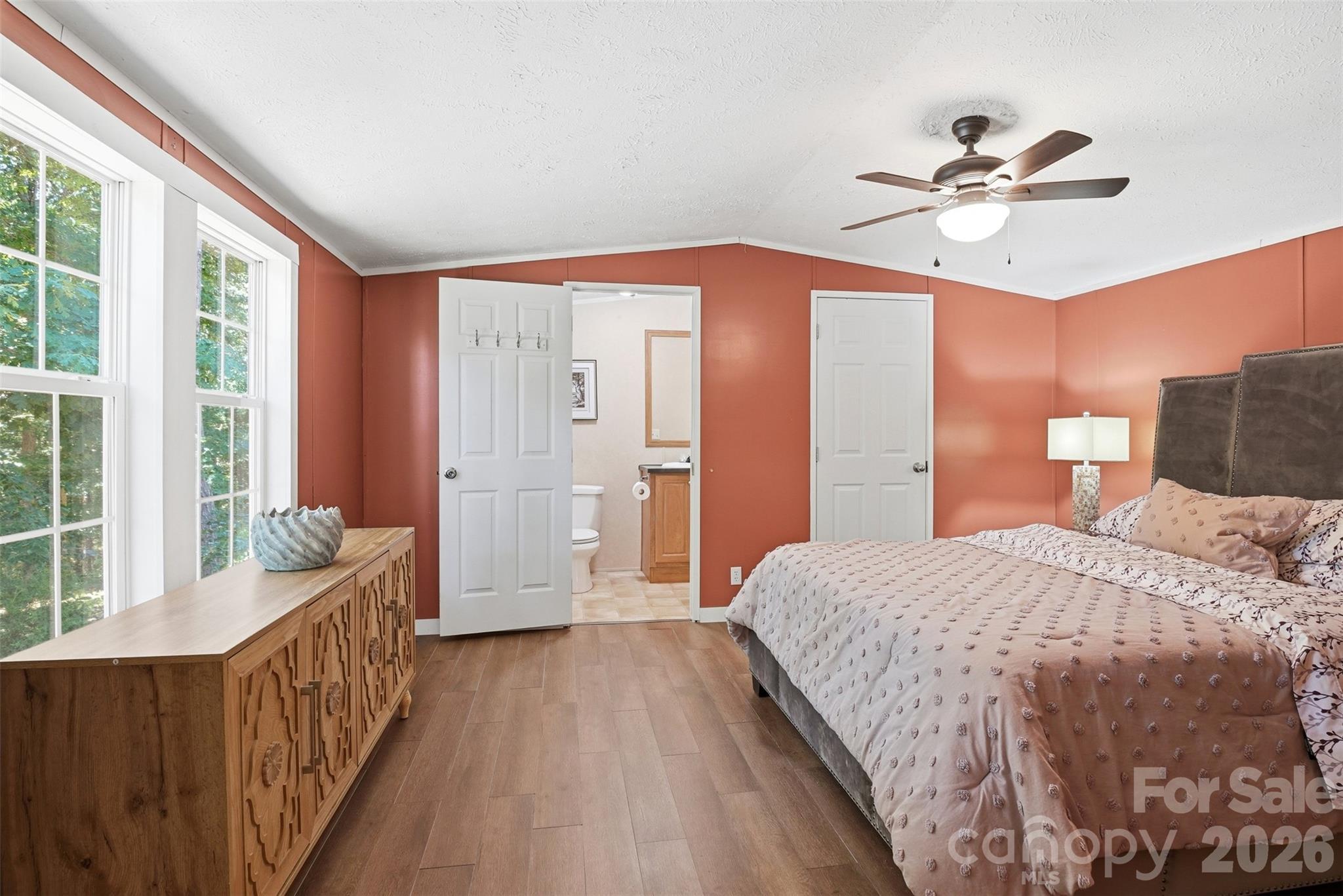 4406 Lucy Short Cut Road Marshville, NC 28103 - Photo 15 of 30 a bedroom with a bed and a chandelier