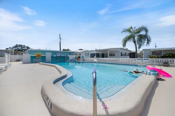 a view of a swimming pool with a table and chairs
