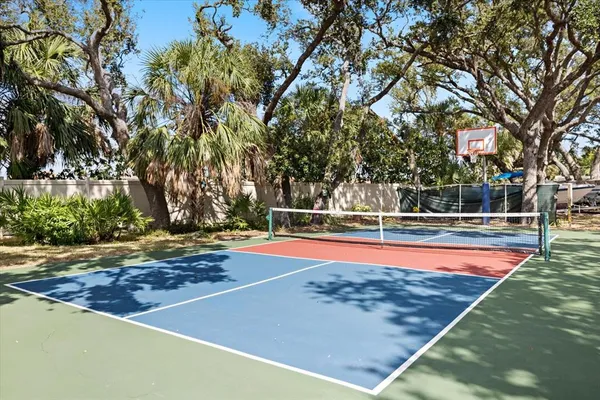 a view of swimming pool with large trees