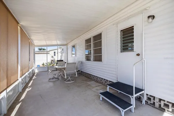 a living room with furniture gym equipment and large windows