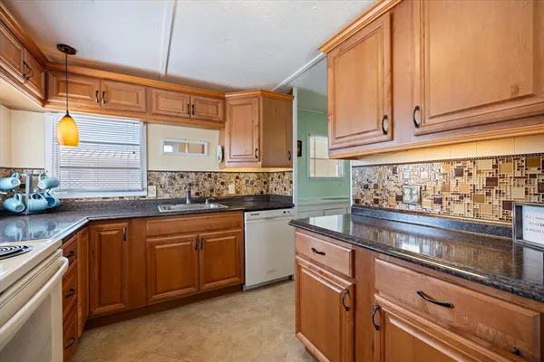 a kitchen with stainless steel appliances granite countertop a sink and cabinets