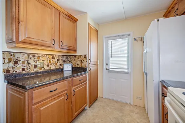 a kitchen with stainless steel appliances granite countertop a refrigerator and a sink