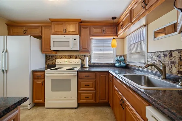 a kitchen with a stove oven and sink