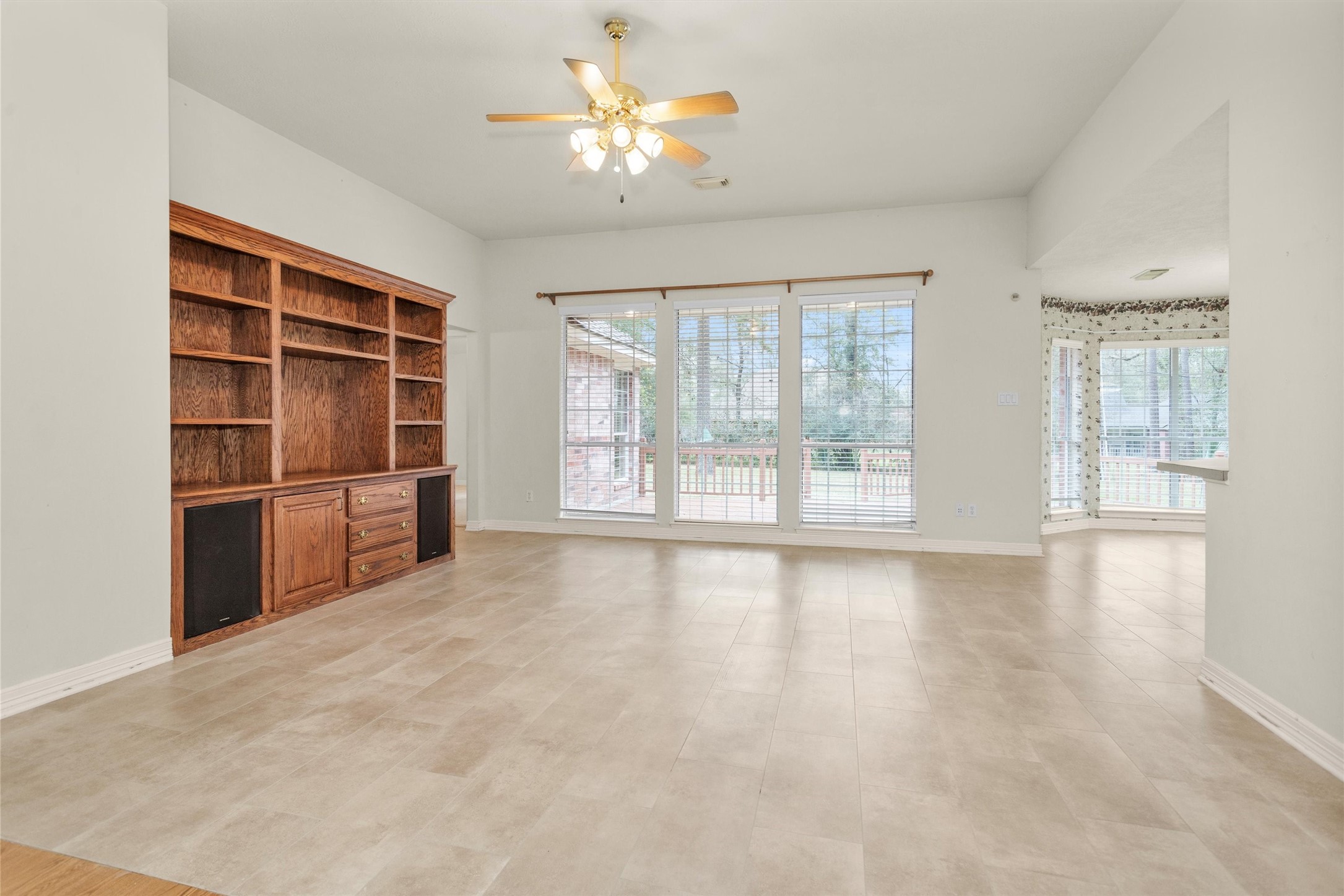 2419 Carriage Ridge Lane Conroe, TX 77384 - Photo 12 of 39 a view of an empty room with a window and kitchen area