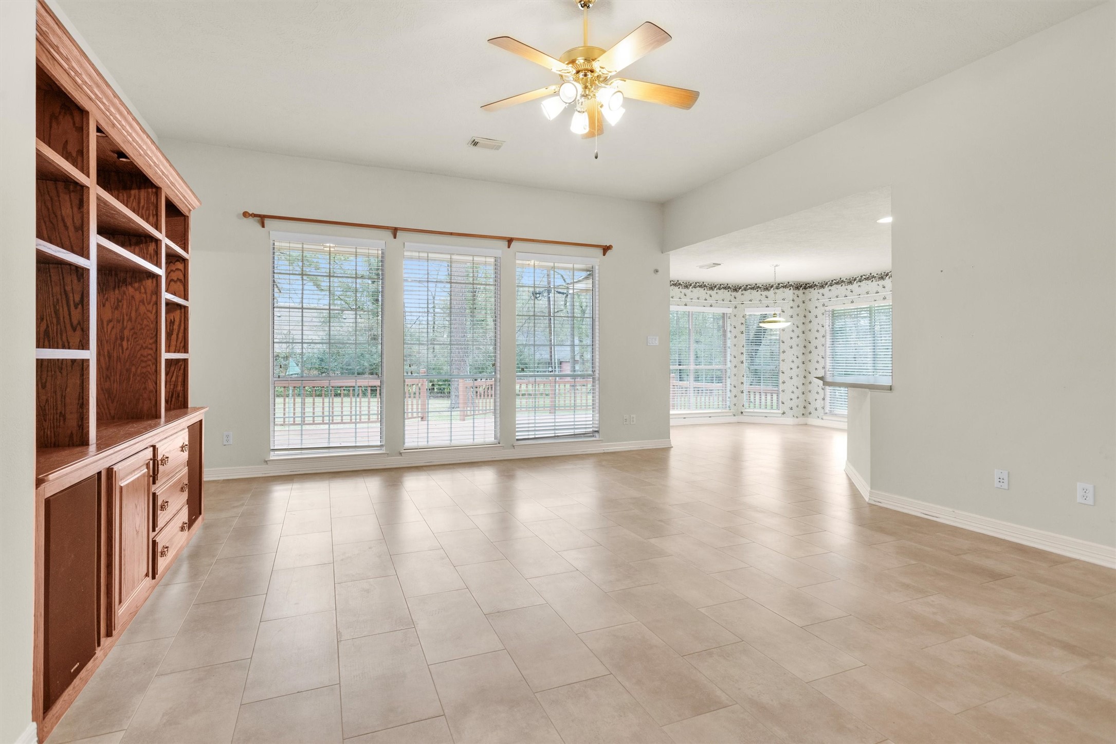 2419 Carriage Ridge Lane Conroe, TX 77384 - Photo 13 of 39 a view of an empty room with a window and wooden floor