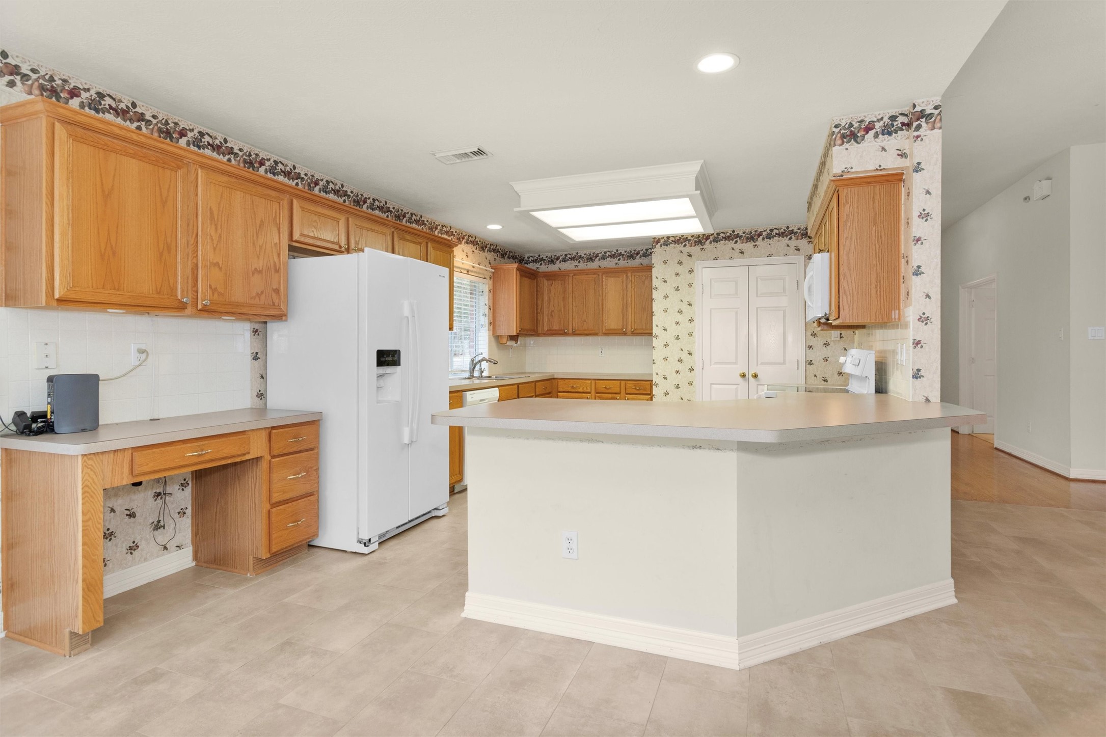 2419 Carriage Ridge Lane Conroe, TX 77384 - Photo 18 of 39 a kitchen with stainless steel appliances granite countertop a sink stove and refrigerator