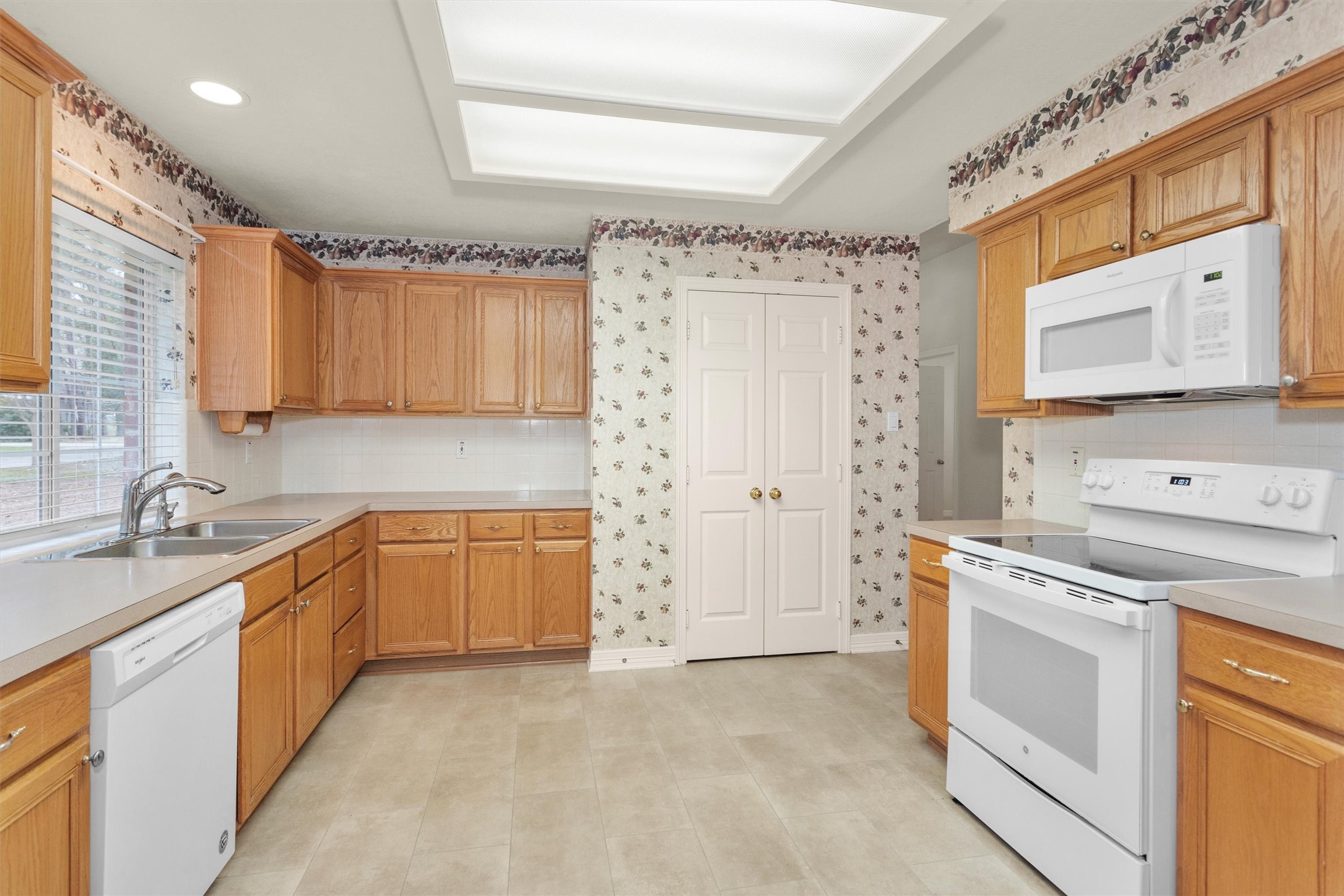 2419 Carriage Ridge Lane Conroe, TX 77384 - Photo 19 of 39 a kitchen with a stove sink and cabinets