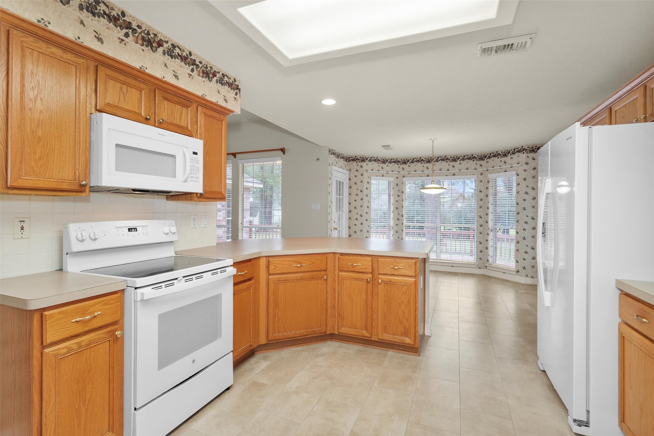2419 Carriage Ridge Lane Conroe, TX 77384 - Photo 20 of 39 a kitchen with stainless steel appliances granite countertop a stove a sink and a refrigerator