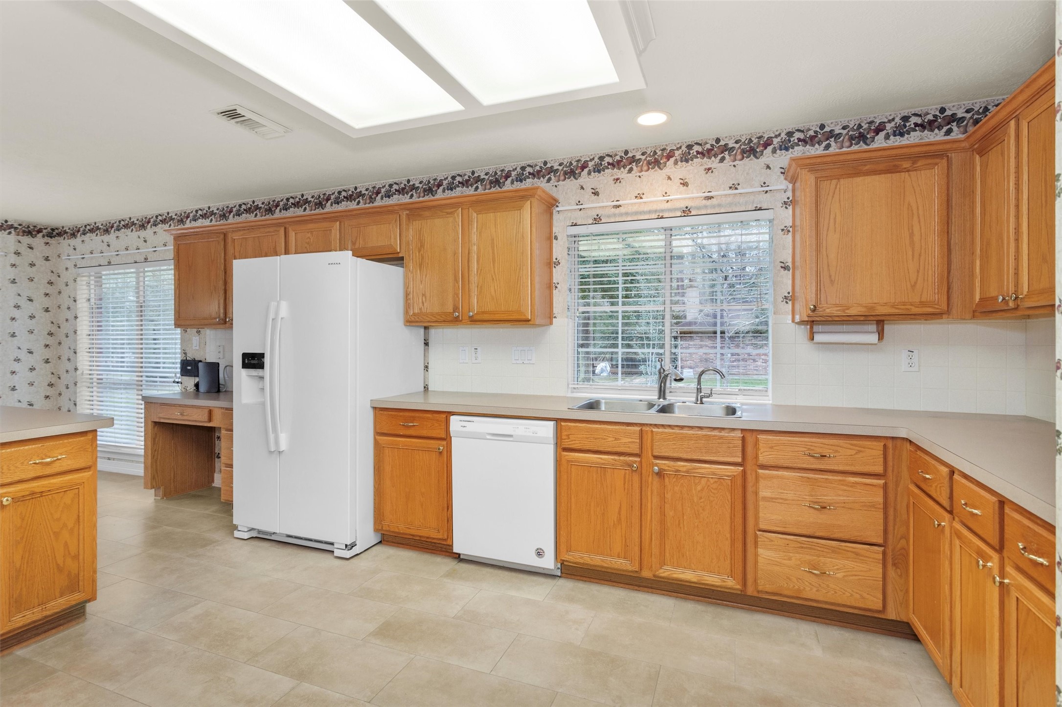 2419 Carriage Ridge Lane Conroe, TX 77384 - Photo 21 of 39 a kitchen with white cabinets and white appliances