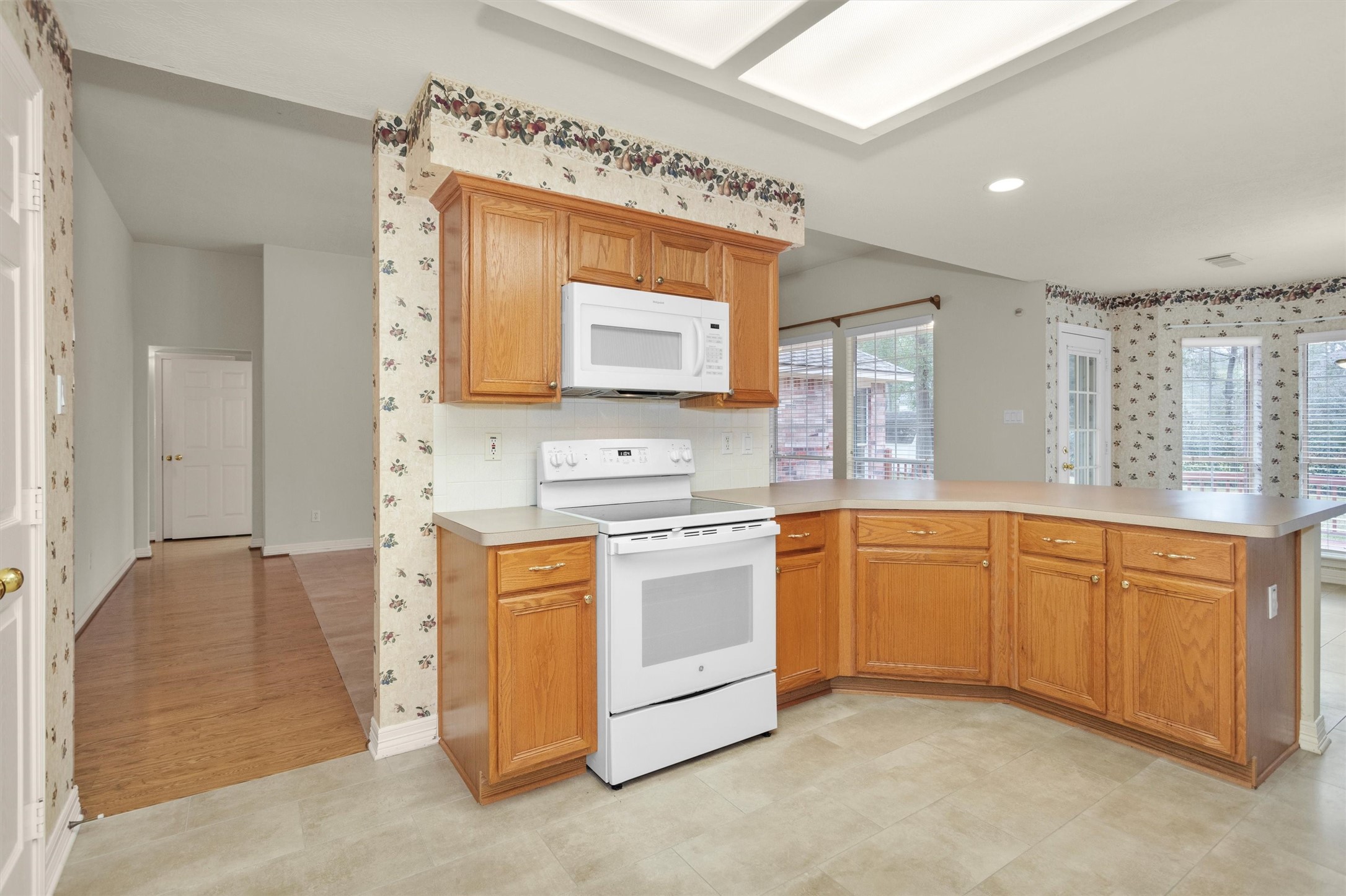 2419 Carriage Ridge Lane Conroe, TX 77384 - Photo 22 of 39 a kitchen with stainless steel appliances granite countertop a stove a sink and a refrigerator