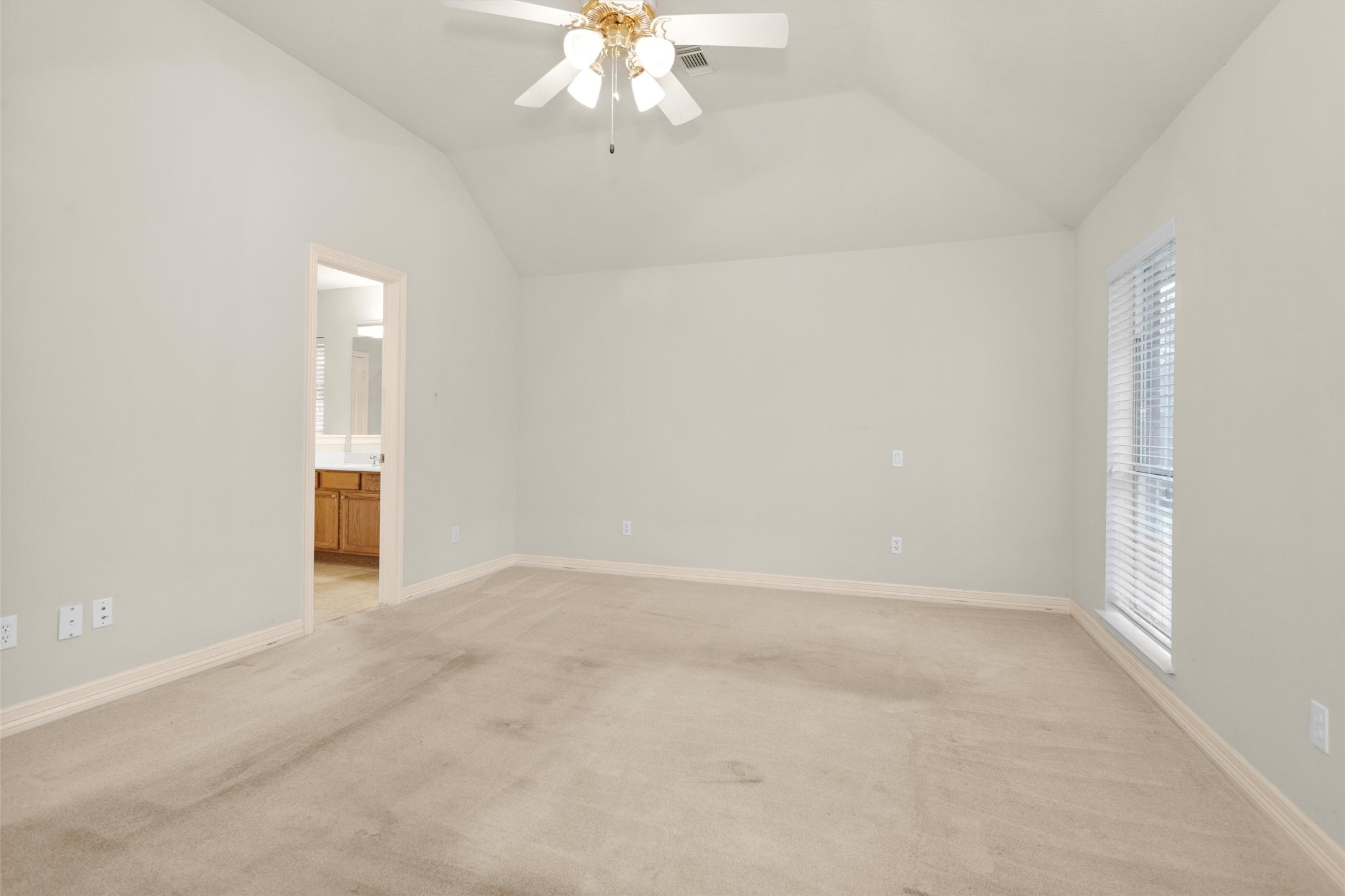 2419 Carriage Ridge Lane Conroe, TX 77384 - Photo 23 of 39 an empty room with a chandelier fan and wooden floor