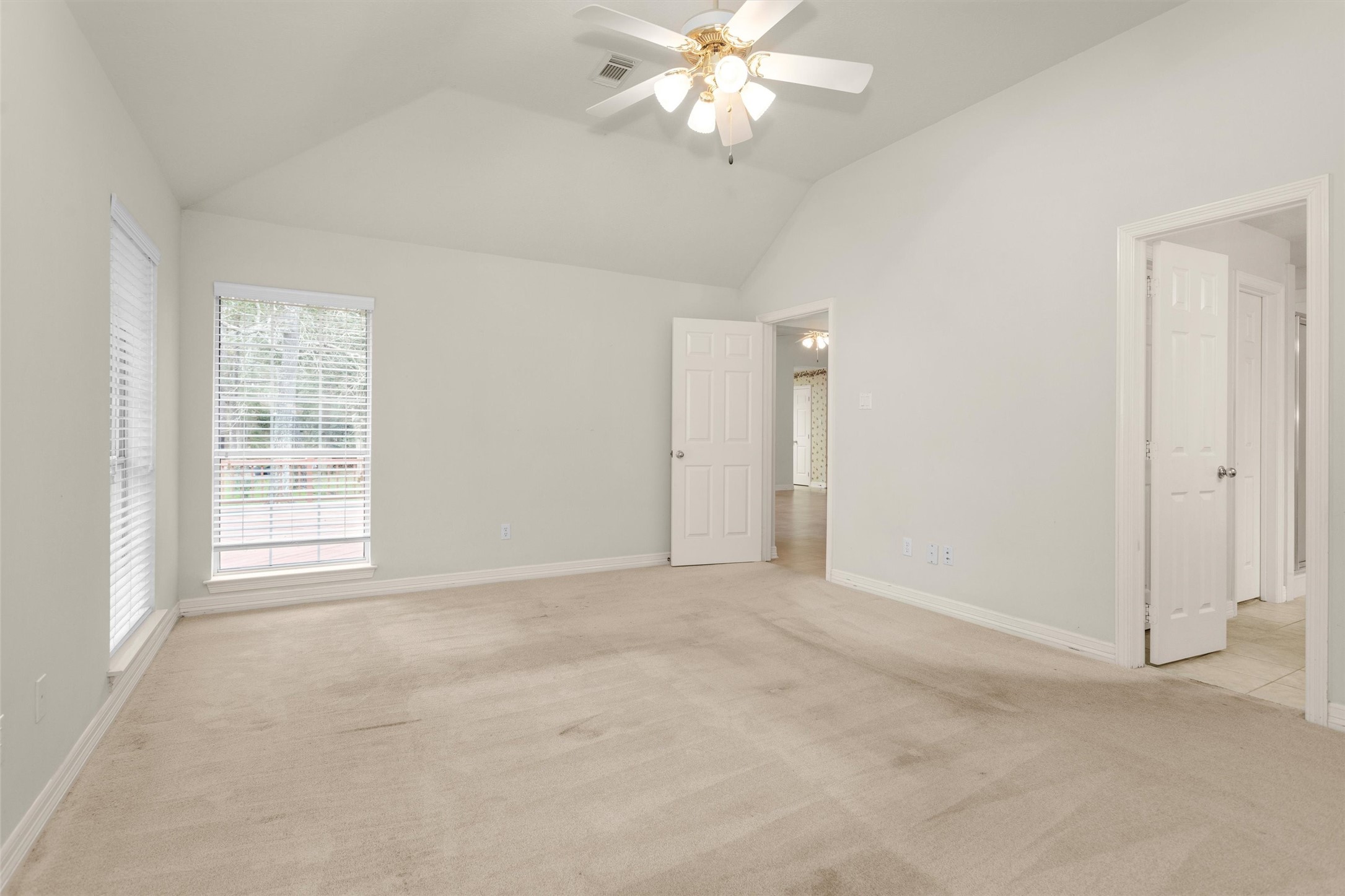 2419 Carriage Ridge Lane Conroe, TX 77384 - Photo 24 of 39 an empty room with windows and fan