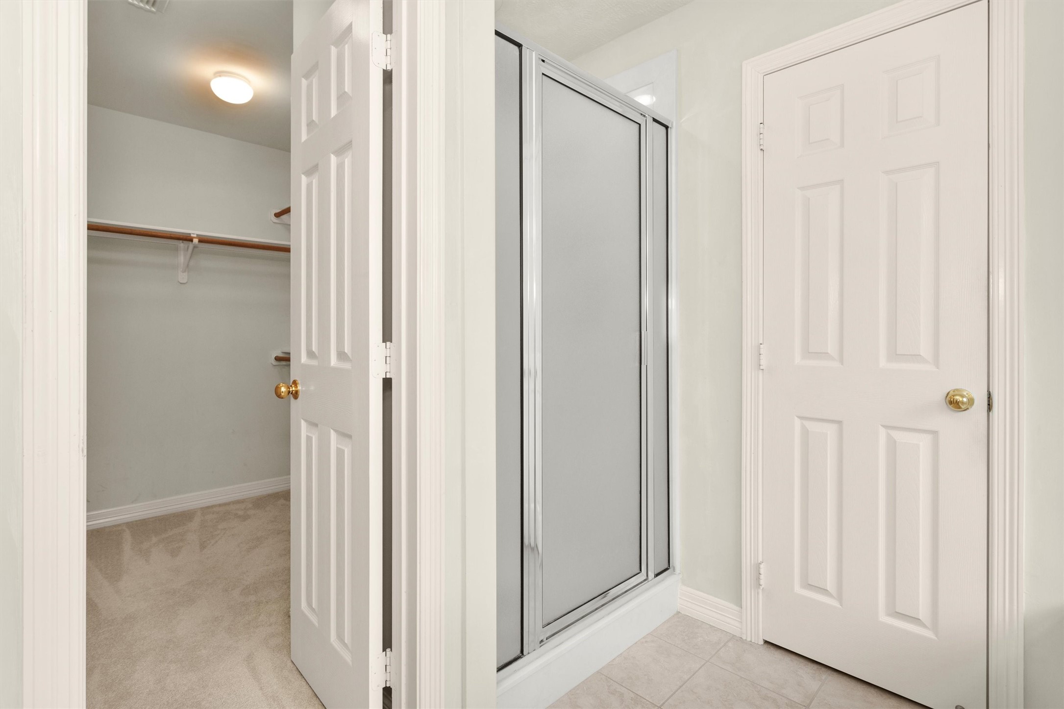 2419 Carriage Ridge Lane Conroe, TX 77384 - Photo 26 of 39 a view of a bathroom with a glass shower door